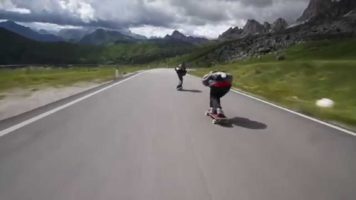 Crazy Downhill Skateboarders Flying By Cyclists